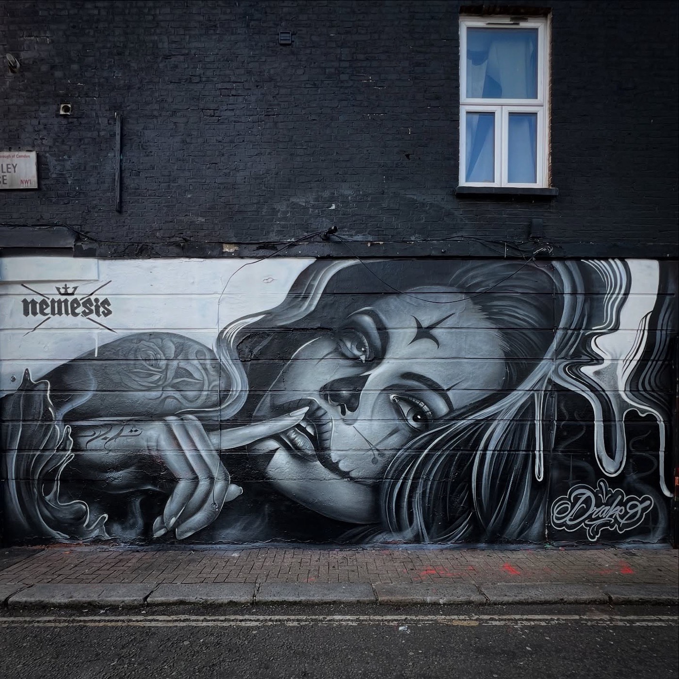 Monochrome portrait street art mural in Camden, London by Top Murals