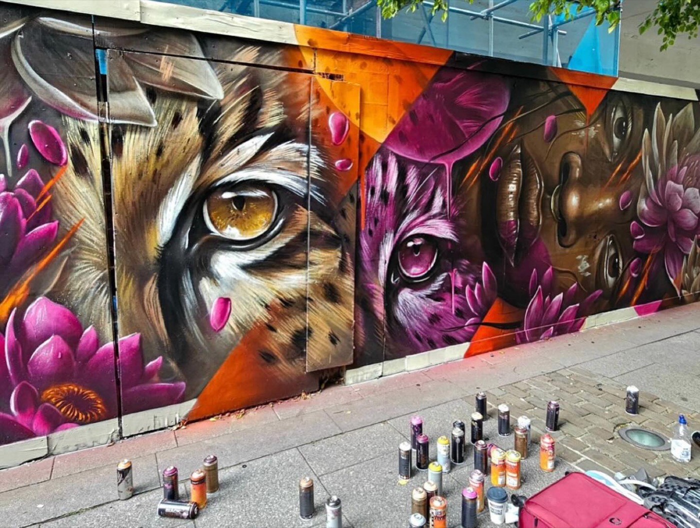 Photoreal leopard and panther eyes wide-format mural by Top Murals